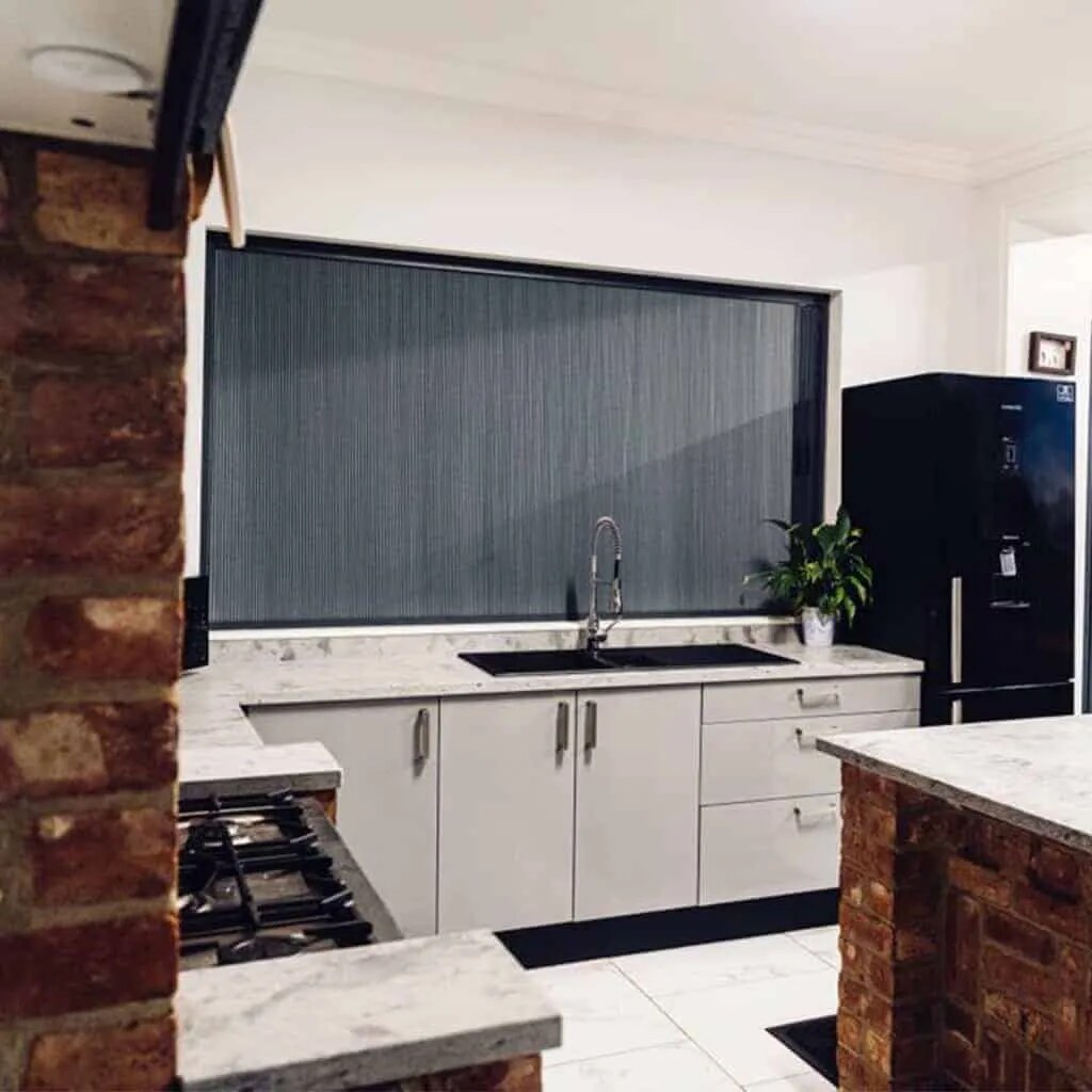 BlindScreen® cellular blackout fabric in a slim frame — a panel-mounted alternative when bifolds need darkness and insect screening.