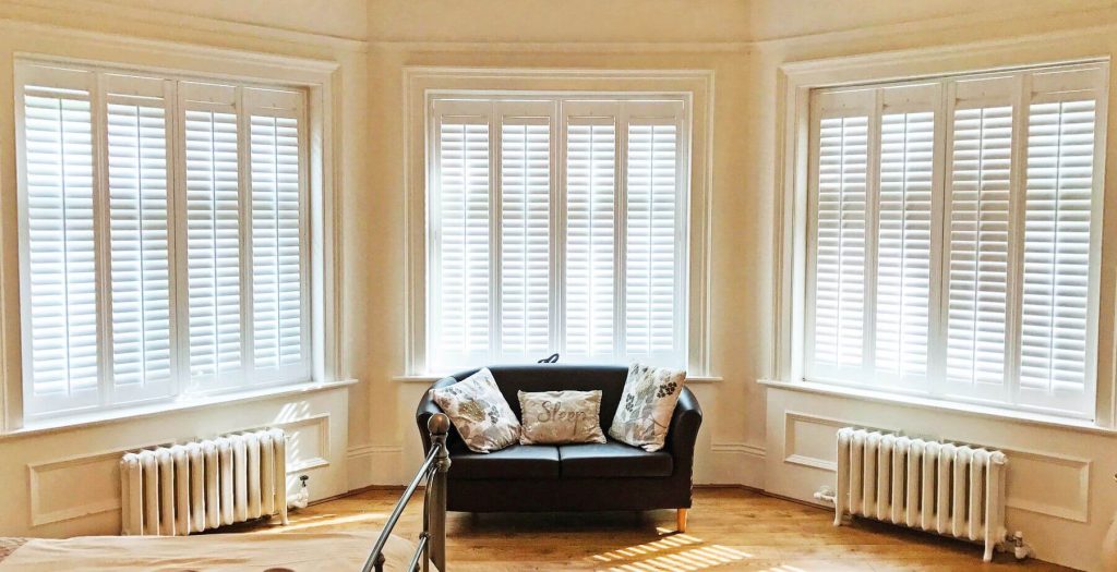 S-Craft plantation shutters on a three-panel splay bay window — the typical street-facing configuration in Leicestershire Victorian and Edwardian terraces.