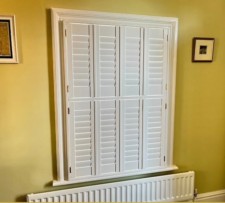 White tier-on-tier shutters fully closed with louvres shut