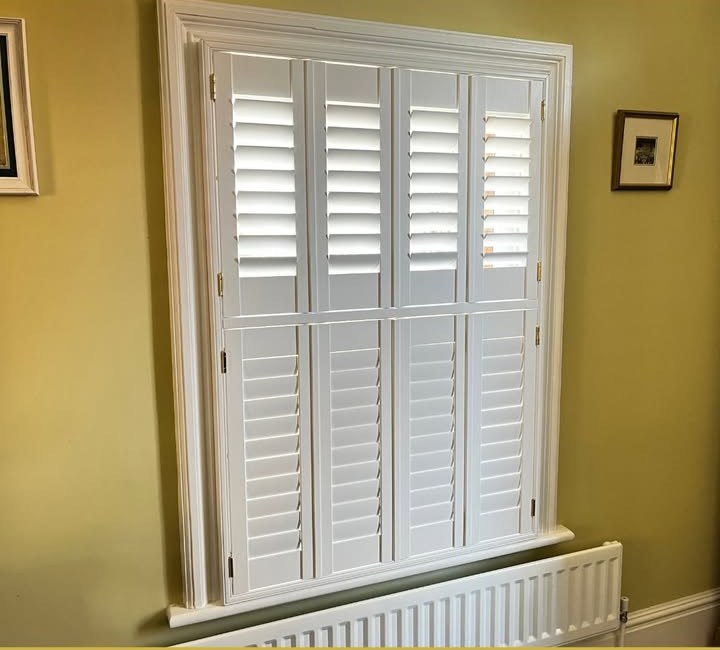 White tier-on-tier shutters fully closed with louvres open