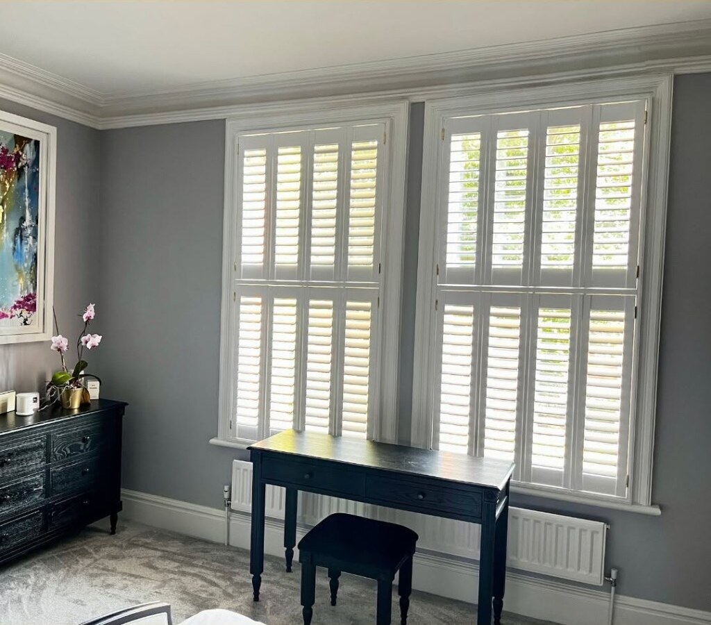 White tier-on-tier shutters fully closed with louvres open for daylight