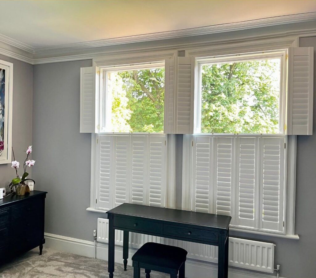 Same tier-on-tier install — upper panels folded back, tree views through the top half of the glass