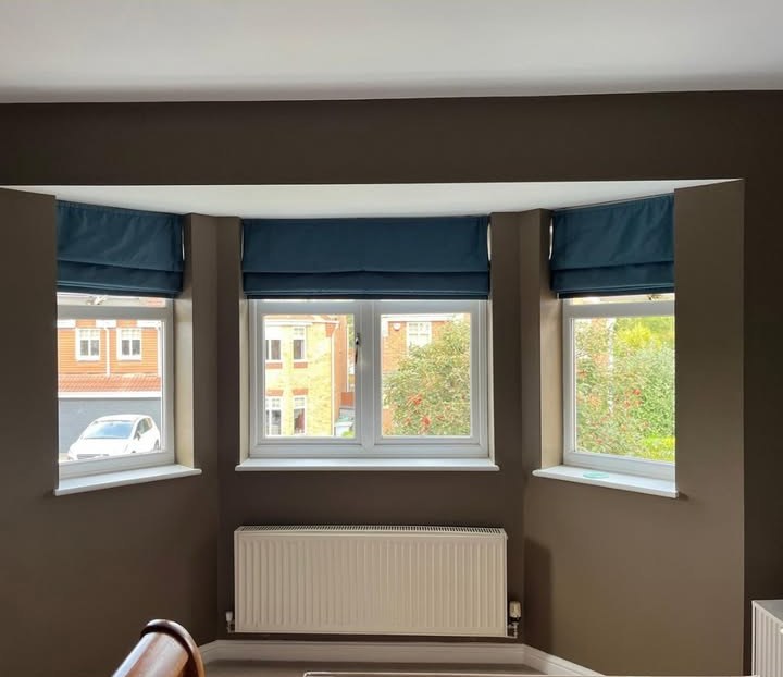 Box bay window in Lowdham before shutters — three blue Roman blinds over the windows